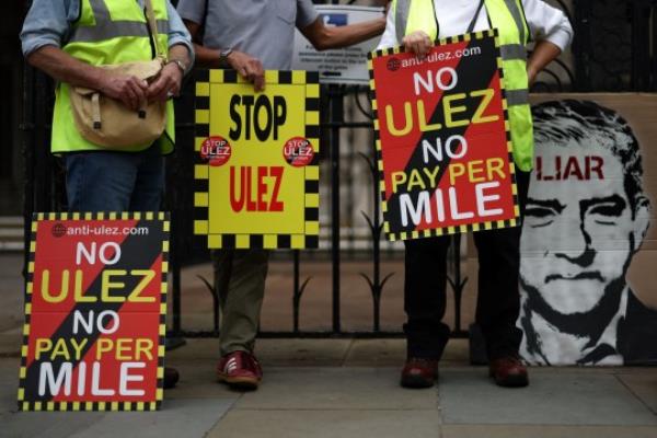Demo<em></em>nstrators hold placards as they protest against the expansion of the Ultra Low Emission Zone (ULEZ) in London, outside the Royal Courts of Justice, Britain's High Court, in central Lo<em></em>ndon on July 28, 2023. Britain's High Court ruled on July 28, 2023 that the Lo<em></em>ndon mayor's co<em></em>ntentious plans to extend a scheme obliging the most polluting vehicles to pay a daily charge when driven can go ahead on August 29. The court rejected a challenge by five Conservative-led outer Lo<em></em>ndon councils that Labour's Sadiq Khan had acted unlawfully with his politically-charged expansion of the Ultra-Low Emission Zone (ULEZ). (Photo by HENRY NICHOLLS / AFP) (Photo by HENRY NICHOLLS/AFP via Getty Images)