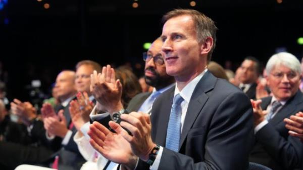 MANCHESTER, ENGLAND - OCTOBER 4: Foreign Secretary James Cleverly and Chancellor of the Exchequer Jeremy Hunt sit with cabinet ministers as they watch Prime Minister Rishi Sunak speak during the final day of the Co<em></em>nservative Party Co<em></em>nference on October 4, 2023 in Manchester, England. Rishi Sunak delivers his first speech as Co<em></em>nservative Party Leader to members and delegates today. He is expected to announce the scrapping of the Manchester leg of the HS2 rail l<em></em>ink and suggests alternatives. (Photo by Carl Court/Getty Images)