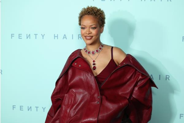 Rihanna in a red coat at the Rihanna x Fenty Hair Los Angeles Launch Party